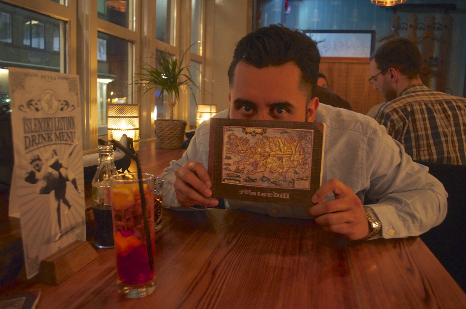Luis at Icelandic Bar with the epic looking menu showing old map of Iceland.