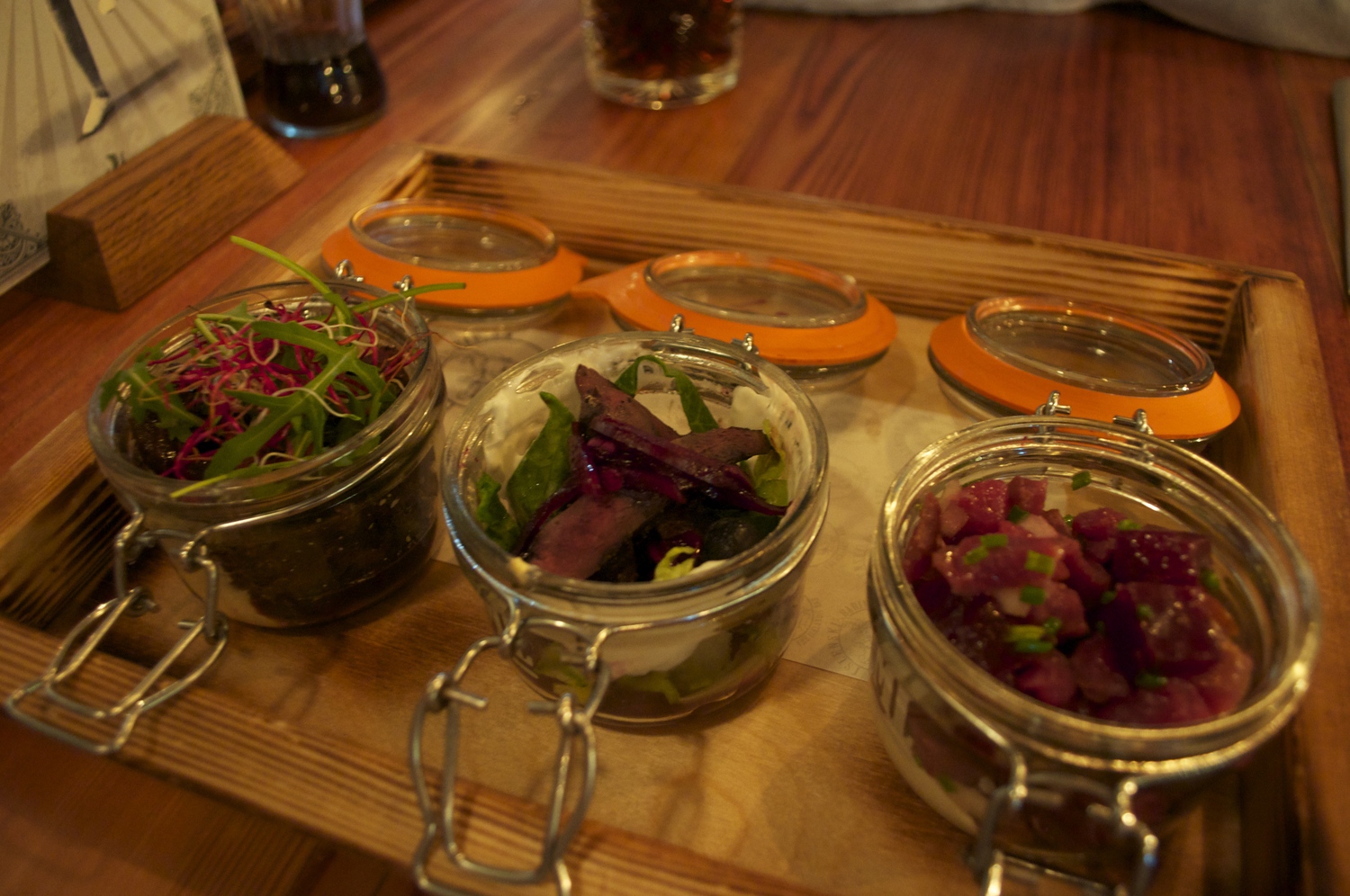 Gumbo's tray of jars - 1) Puffin, blueberry onion, lemon skyr dressing & blueberries 2) Grilled minke whale & deep fried shrimps & blueberry glaze 3) Smoked lamb tartar, beet root, onion & horseradish,