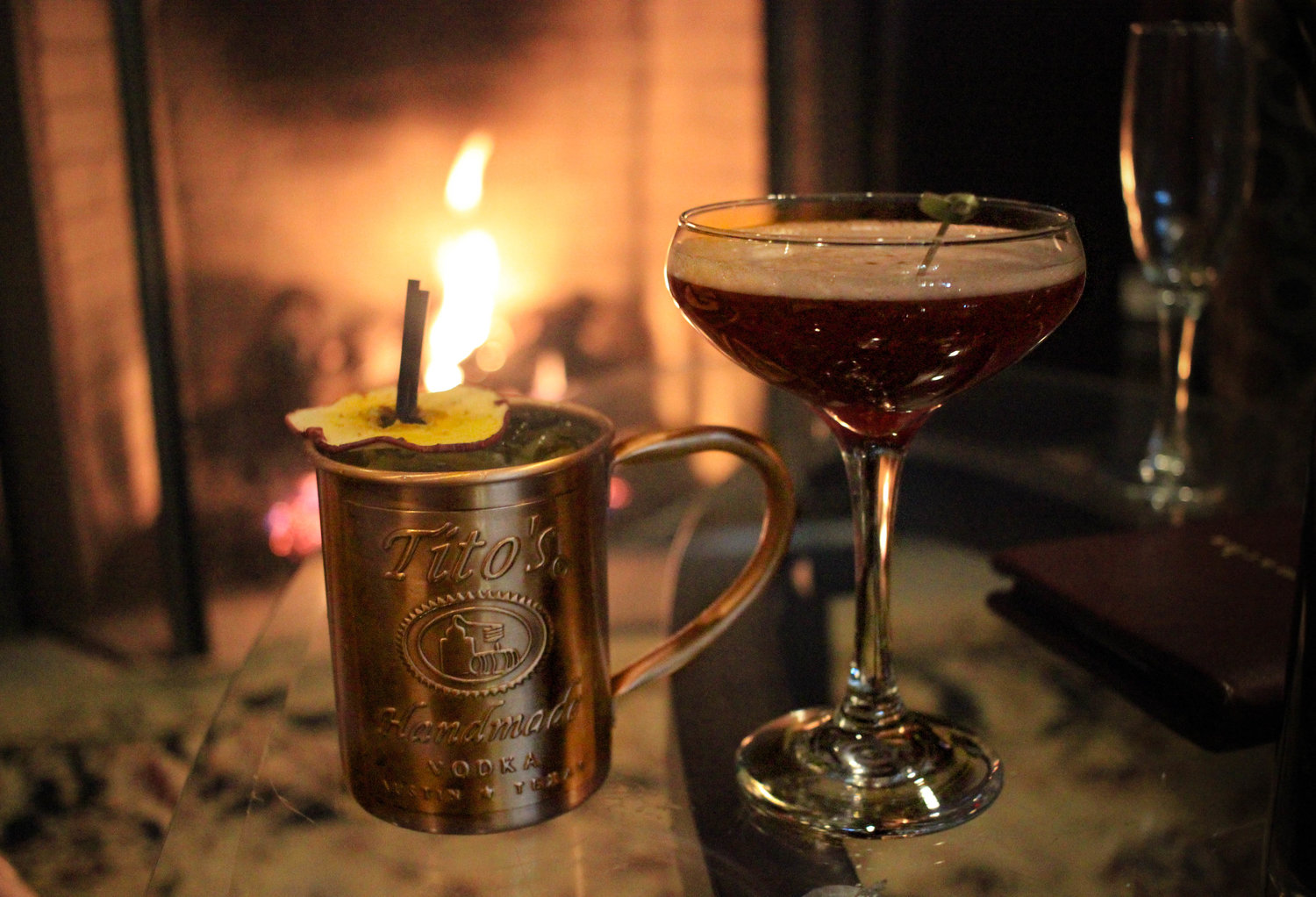 Left: The Autumn Mule;  Tito’s vodka infused with clove and ginger, peach puree, ginger beer. Right: The Sleepy Hollow; Chai tea infused brandy, cranberry liqueur, pumpkin spiced agave nectar, Sparkling Wine.