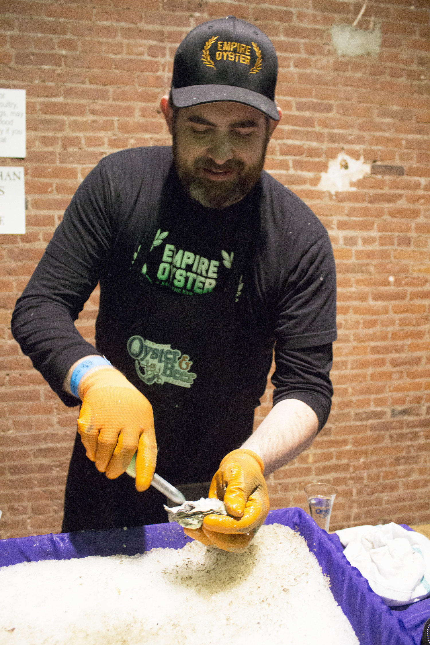 Empire Oyster is shucked then topped with horseradish and Tabasco sauce