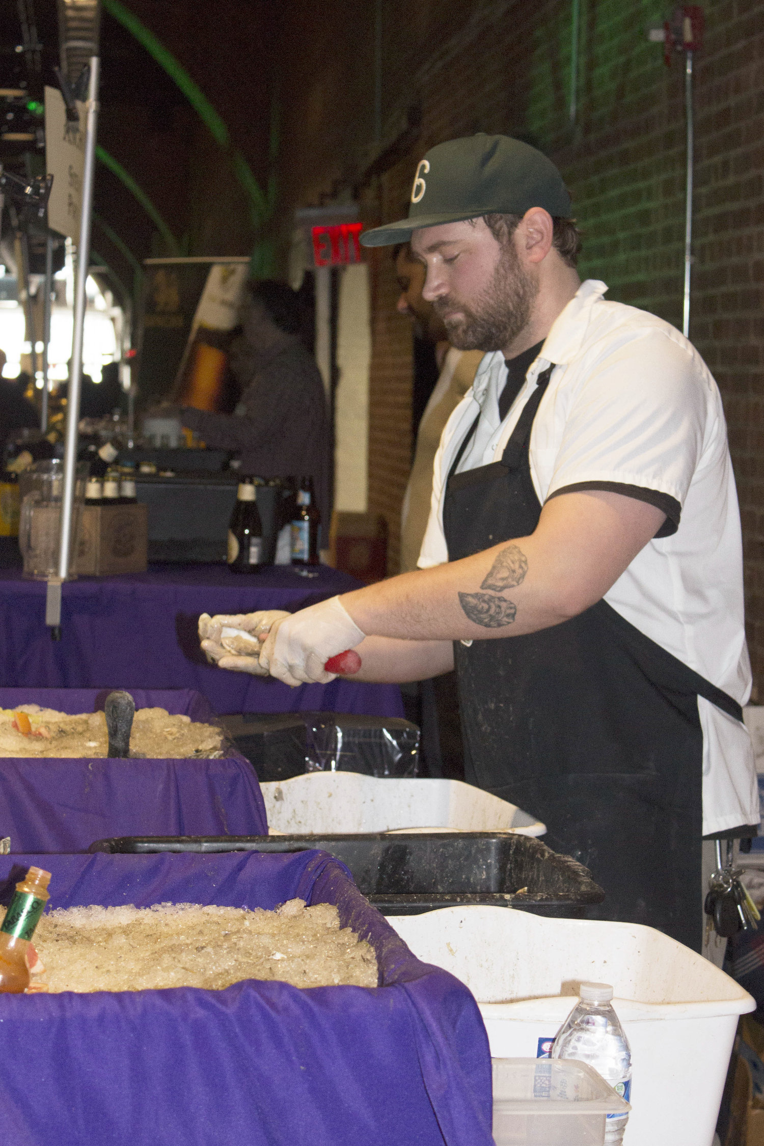 Oyster shucker with complimentary matching tattoo. 