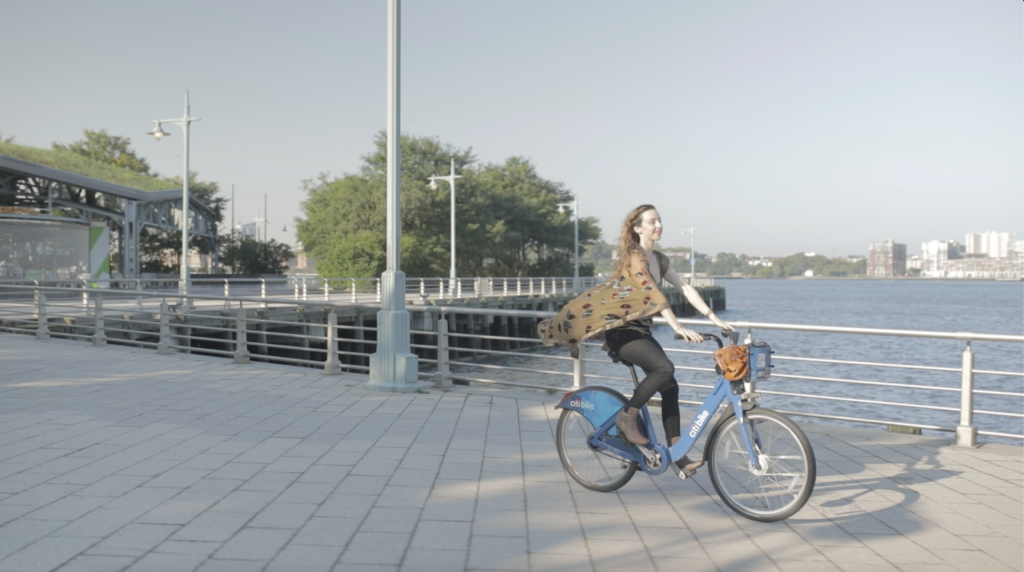 Sarah Funk riding a Citi Bike along the Hudson River