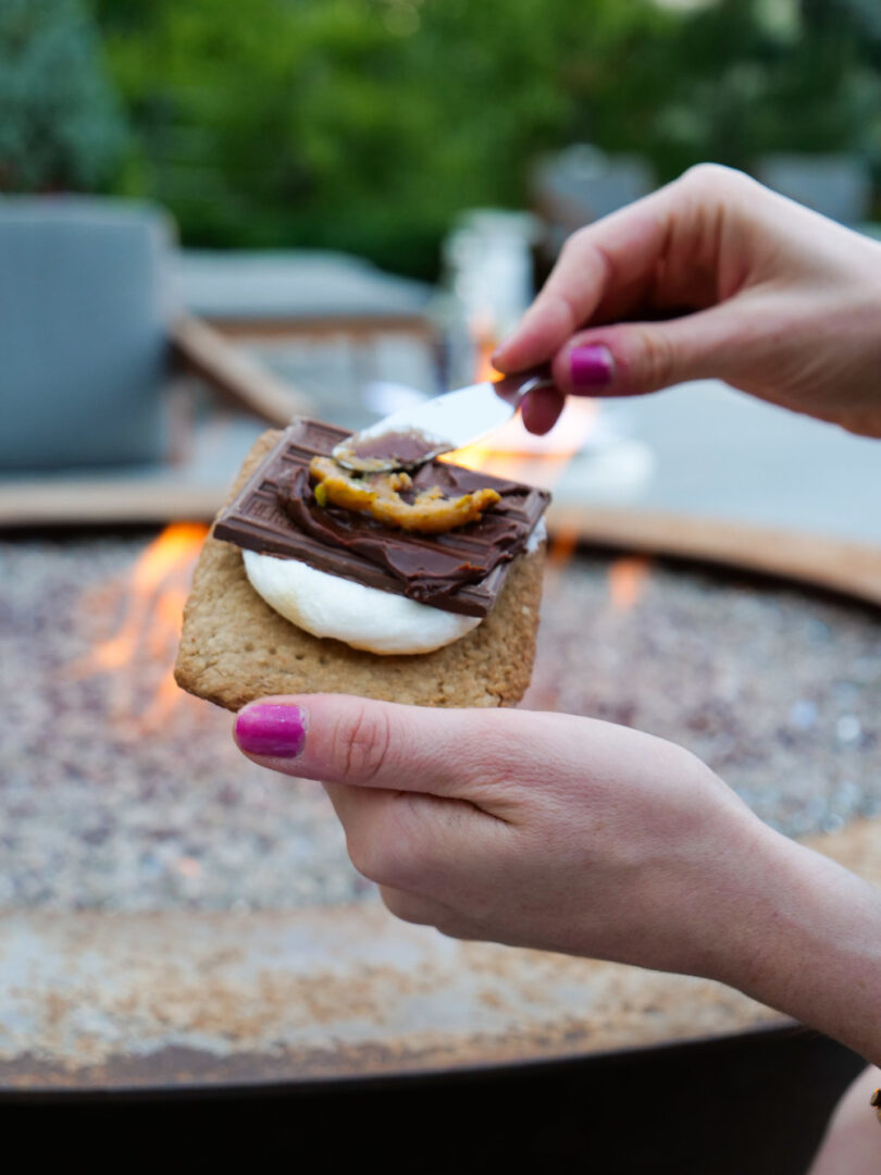 Putting the peanut and pistacio spread on the s'more